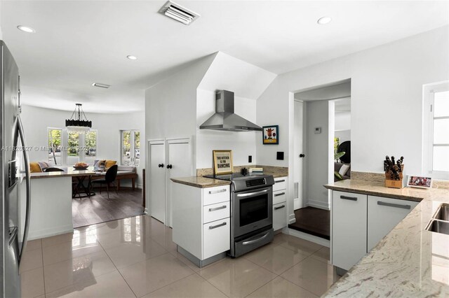 600 NE 55th Ter, Miami, FL 33137 - kitchen with stainless steel appliances, wall chimney exhaust hood, light stone counters, recessed lighting, and pendant lighting
