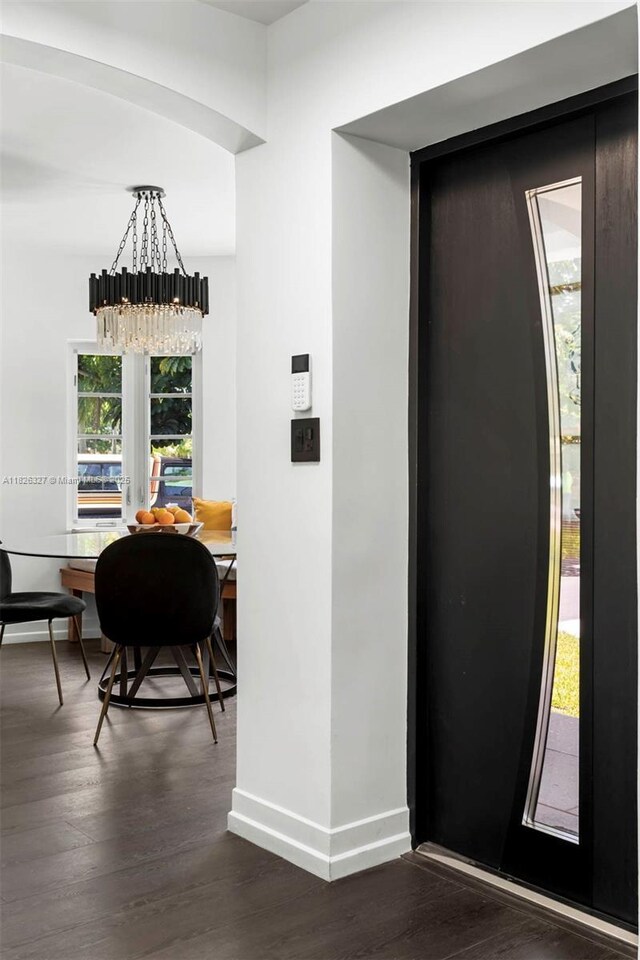 600 NE 55th Ter, Miami, FL 33137 - foyer entrance with elevator, dark wood finished floors, and a chandelier