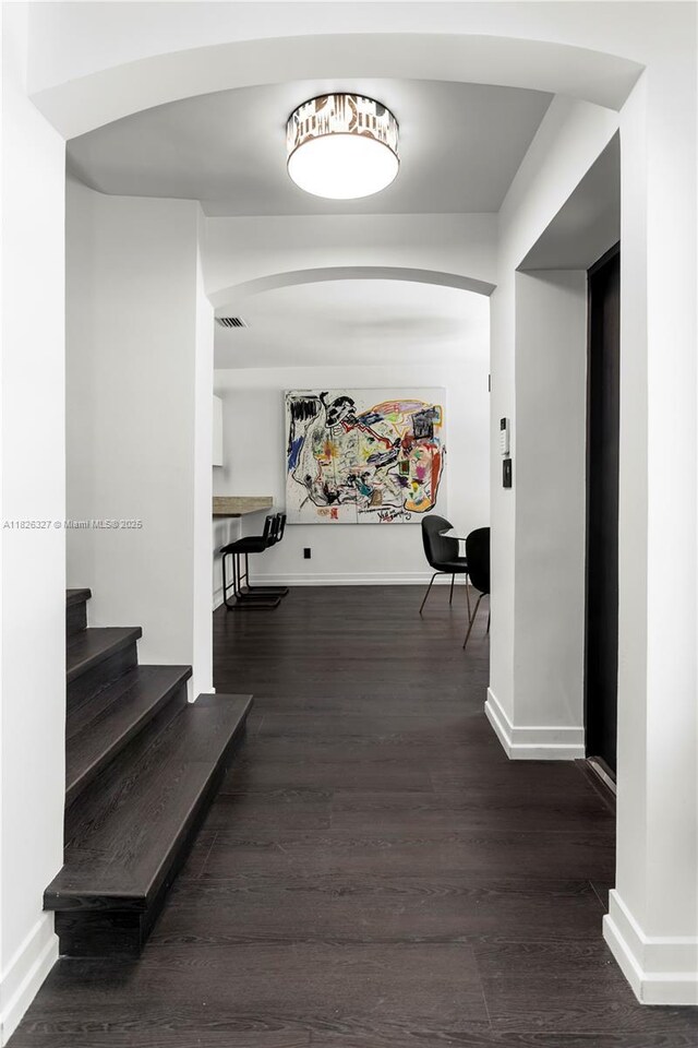 600 NE 55th Ter, Miami, FL 33137 - hallway featuring arched walkways and wood finished floors
