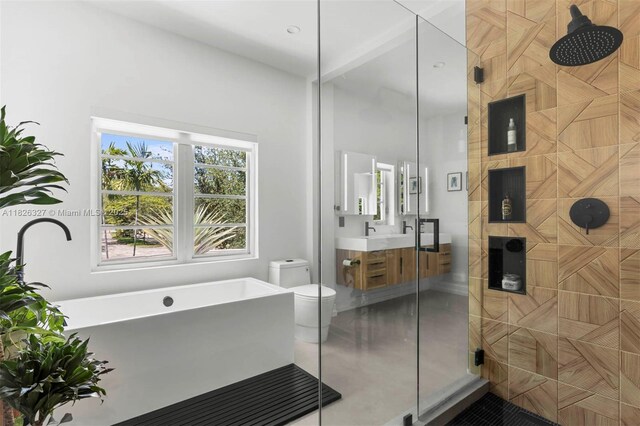 600 NE 55th Ter, Miami, FL 33137 - full bathroom featuring tiled shower, vanity, a freestanding bath, and tile patterned floors