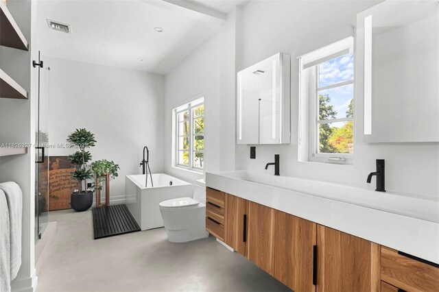 600 NE 55th Ter, Miami, FL 33137 - full bathroom with double vanity, a soaking tub, and concrete flooring