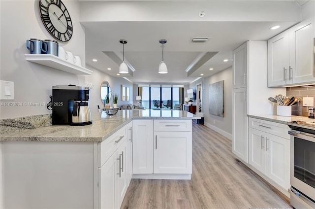 200 Ocean Trail Way Unit 701, Jupiter, FL 33477 - kitchen with stainless steel electric stove, white cabinets, a peninsula, open shelves, and recessed lighting