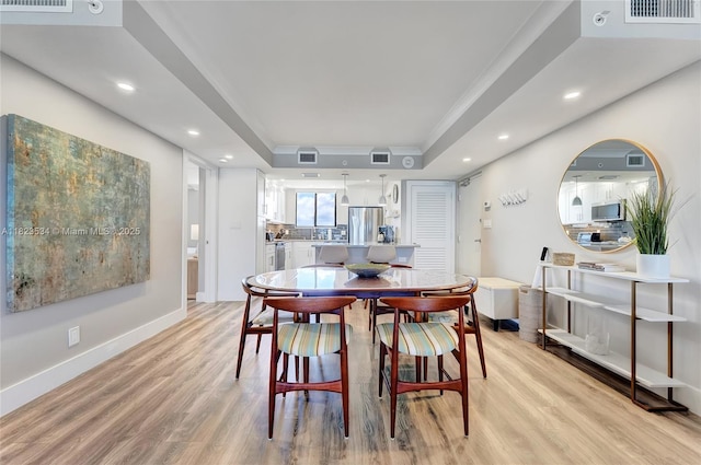 200 Ocean Trail Way Unit 701, Jupiter, FL 33477 - dining space featuring light wood finished floors, a raised ceiling, recessed lighting, and crown molding
