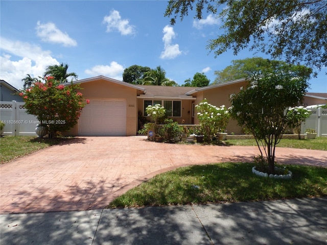 5501 Johnson St, Hollywood, FL 33021 - view of front facade with decorative driveway, an attached garage, stucco siding, and brick siding