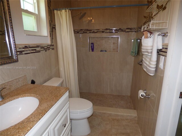 5501 Johnson St, Hollywood, FL 33021 - full bath with vanity, a tile shower, and tile walls
