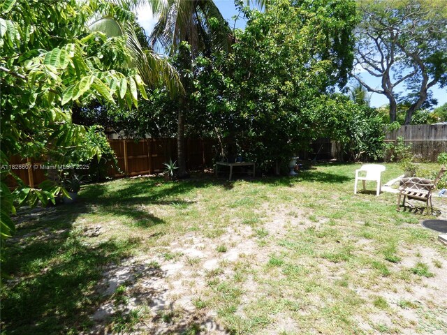5501 Johnson St, Hollywood, FL 33021 - fenced backyard featuring an outdoor fire pit