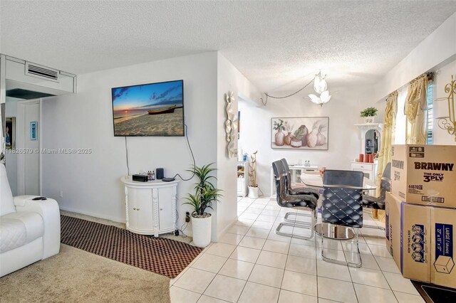 13355 SW 9th Ct Unit 413H, Pembroke Pines, FL 33027 - living room featuring a textured ceiling, a chandelier, and light tile patterned floors