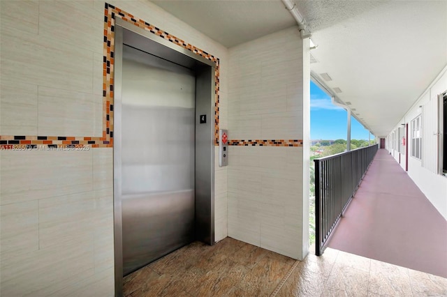 13355 SW 9th Ct Unit 413H, Pembroke Pines, FL 33027 - corridor with elevator and tile walls