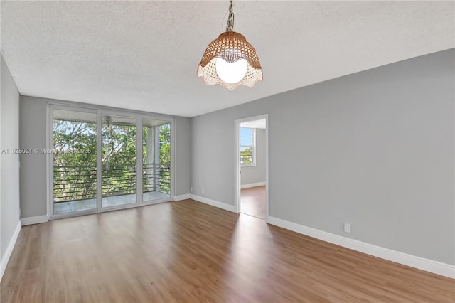 9311 Orange Grove Dr Unit 409, Davie, FL 33324 - unfurnished room with a chandelier, wood finished floors, and a textured ceiling