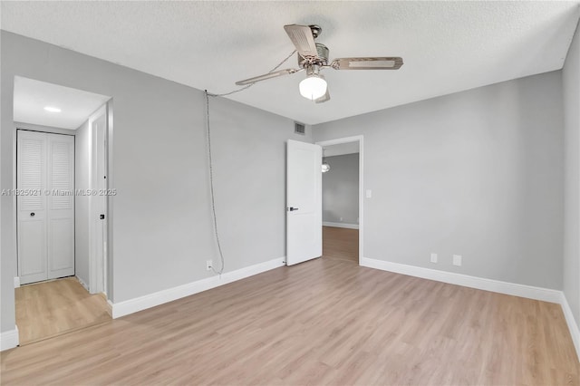 9311 Orange Grove Dr Unit 409, Davie, FL 33324 - unfurnished bedroom with light wood-style floors, a textured ceiling, and ceiling fan
