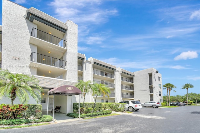 9311 Orange Grove Dr Unit 409, Davie, FL 33324 - view of apartment building / complex with uncovered parking