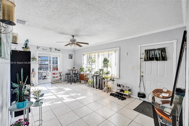 17415 NW 27th Ct, Miami Gardens, FL 33056 - foyer featuring ceiling fan, light tile patterned flooring, a textured ceiling, and crown molding