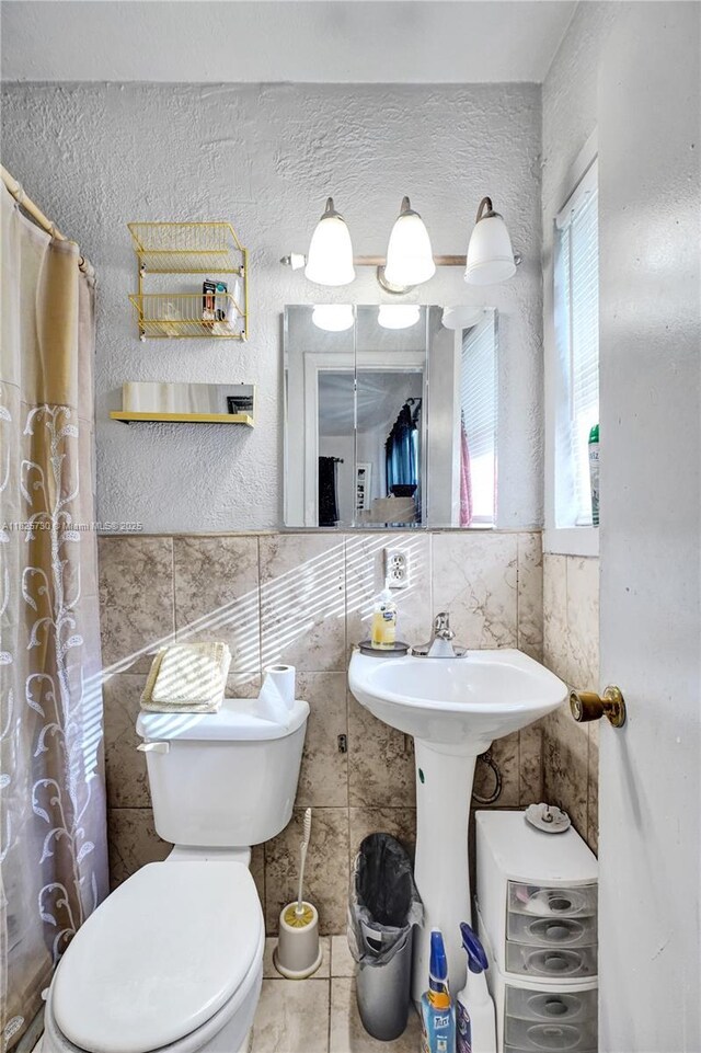 17415 NW 27th Ct, Miami Gardens, FL 33056 - bathroom featuring tile walls and curtained shower