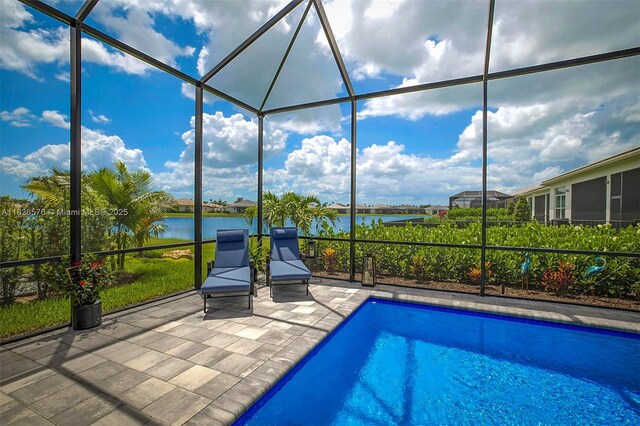 9190 SW Esule Way, Port St Lucie, FL 34987 - outdoor pool featuring a water view, a patio area, and a lanai
