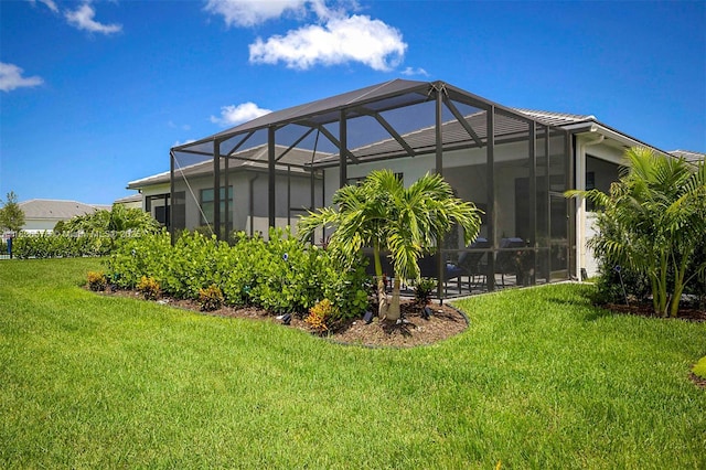 9190 SW Esule Way, Port St Lucie, FL 34987 - back of property featuring a yard and glass enclosure