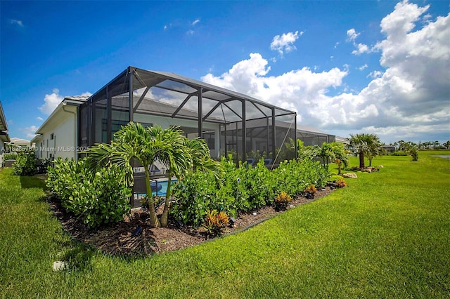 9190 SW Esule Way, Port St Lucie, FL 34987 - rear view of property with a lawn, stucco siding, a lanai, and an outdoor pool