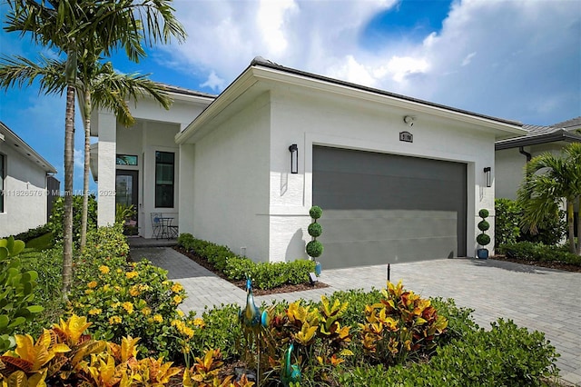 9190 SW Esule Way, Port St Lucie, FL 34987 - view of front of property with stucco siding, a garage, and decorative driveway
