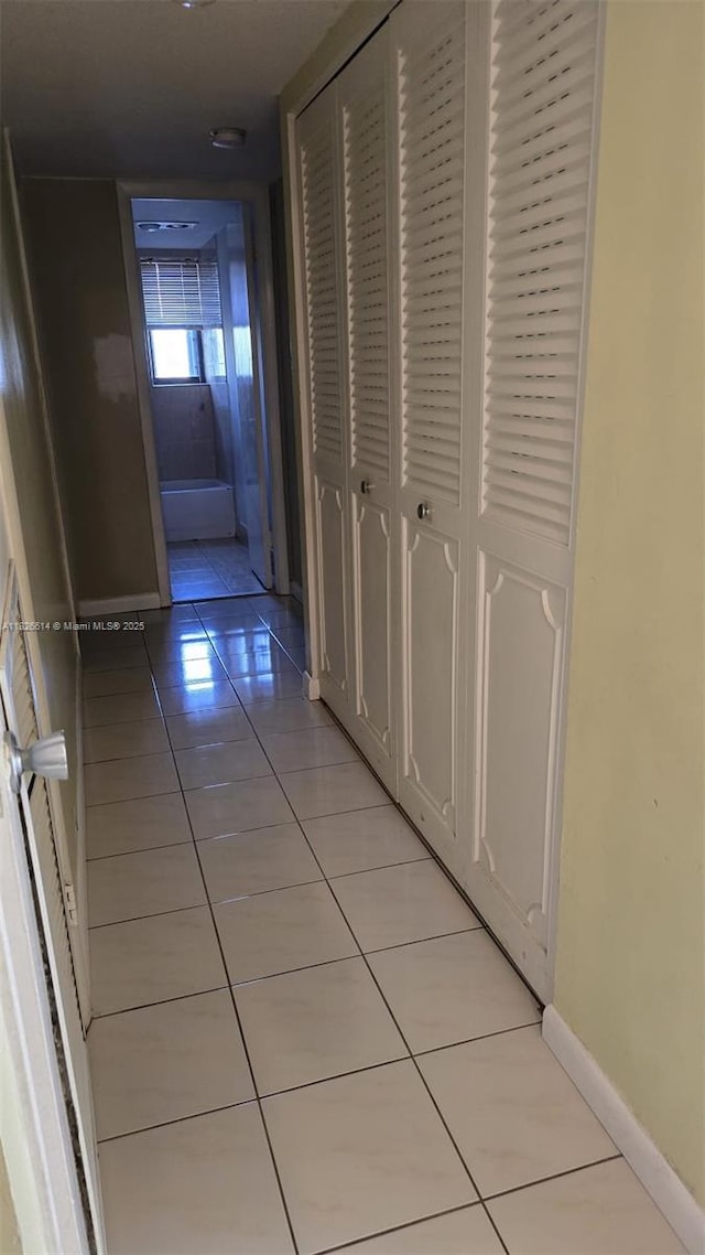 20441 NE 30th Ave Unit 114-9, Aventura, FL 33180 - hallway with light tile patterned floors and baseboards
