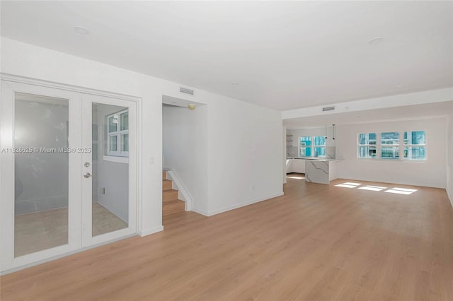 824 SE 12th Ct Unit 1, Fort Lauderdale, FL 33316 - empty room featuring french doors, light wood-style flooring, and stairs
