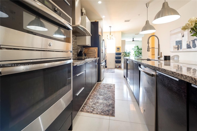 10260 NW 63rd Ter Unit 208, Doral, FL 33178 - kitchen with stainless steel appliances, light tile patterned flooring, backsplash, dark cabinetry, and recessed lighting