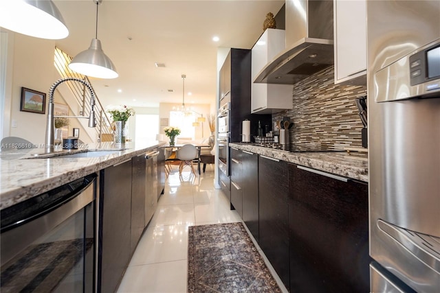 10260 NW 63rd Ter Unit 208, Doral, FL 33178 - kitchen featuring wall chimney range hood, wine cooler, backsplash, light tile patterned floors, and pendant lighting