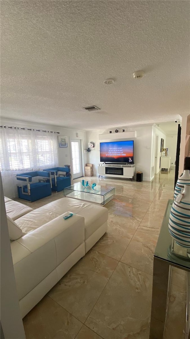 7809 NW 40th Ct, Coral Springs, FL 33065 - living room with a textured ceiling and marble finish flooring