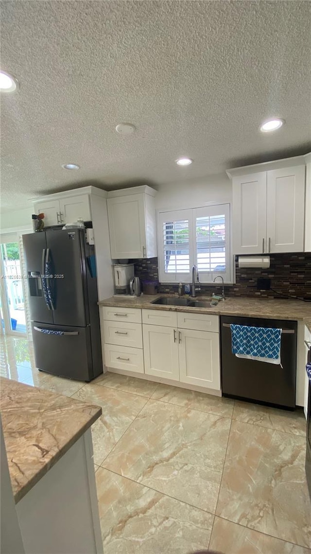 7809 NW 40th Ct, Coral Springs, FL 33065 - kitchen featuring stainless steel appliances, a textured ceiling, recessed lighting, white cabinets, and backsplash