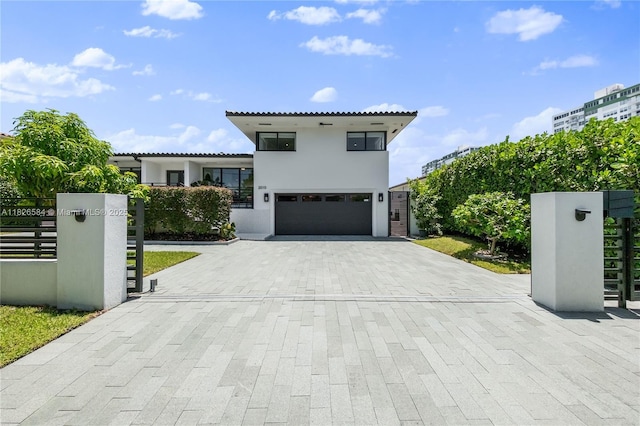 2010 NE 122nd Rd, North Miami, FL 33181 - view of front of home featuring an attached garage, decorative driveway, and stucco siding