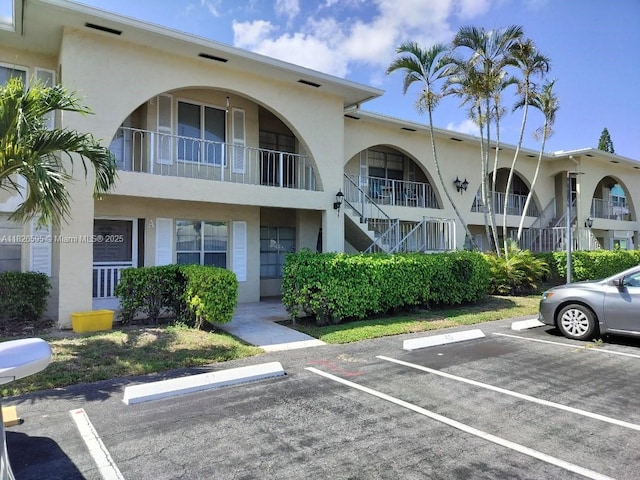 13791 Flora Pl Unit B, Delray Beach, FL 33484 - view of property with uncovered parking and stairway