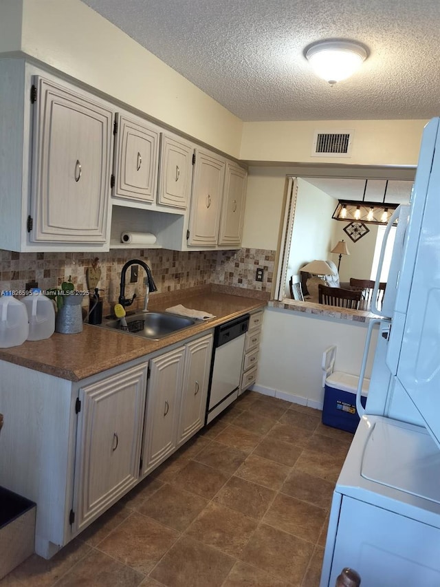 13791 Flora Pl Unit B, Delray Beach, FL 33484 - kitchen featuring white dishwasher, tasteful backsplash, and a textured ceiling