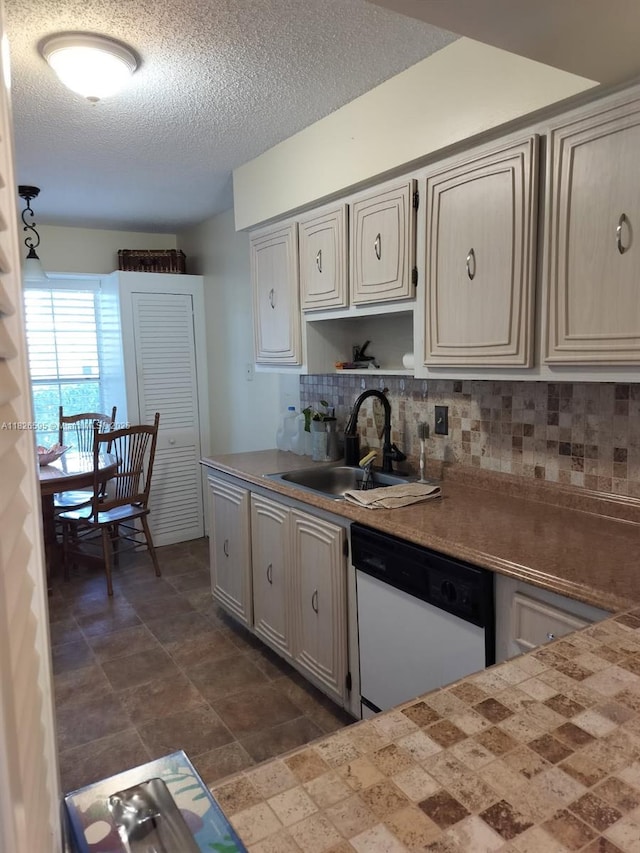 13791 Flora Pl Unit B, Delray Beach, FL 33484 - kitchen featuring white dishwasher, backsplash, a textured ceiling, and light countertops