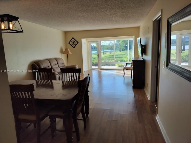 13791 Flora Pl Unit B, Delray Beach, FL 33484 - dining area featuring wood finished floors, healthy amount of natural light, and a textured ceiling