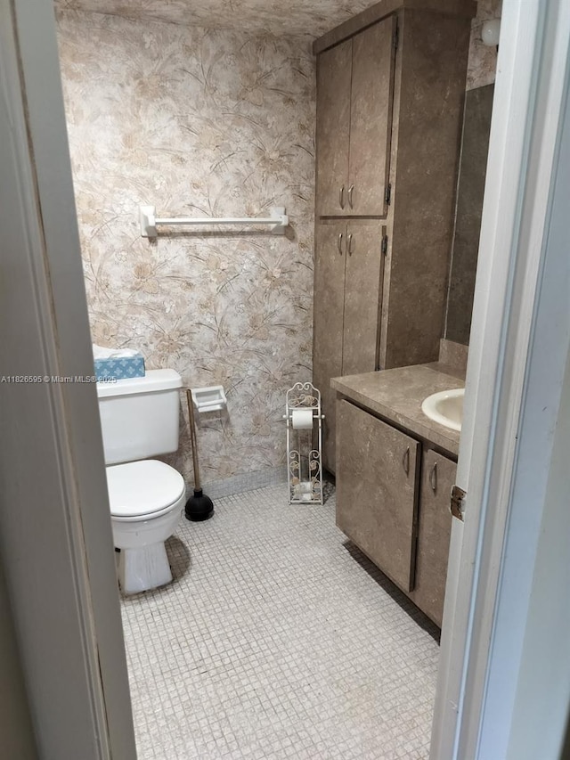 13791 Flora Pl Unit B, Delray Beach, FL 33484 - half bathroom featuring vanity and wallpapered walls