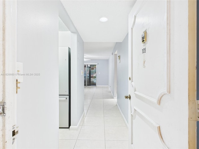 4113 NW 88th Ave Unit 105, Coral Springs, FL 33065 - hallway featuring light tile patterned floors and baseboards