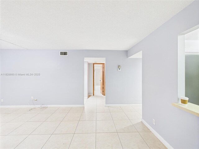 4113 NW 88th Ave Unit 105, Coral Springs, FL 33065 - empty room featuring light tile patterned floors and a textured ceiling