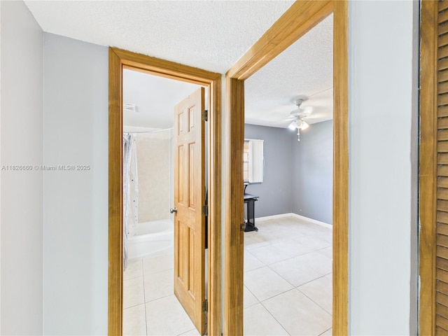 4113 NW 88th Ave Unit 105, Coral Springs, FL 33065 - hall featuring light tile patterned floors and a textured ceiling