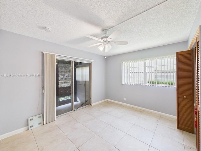 4113 NW 88th Ave Unit 105, Coral Springs, FL 33065 - spare room featuring a ceiling fan, light tile patterned flooring, a textured ceiling, and a smoke detector