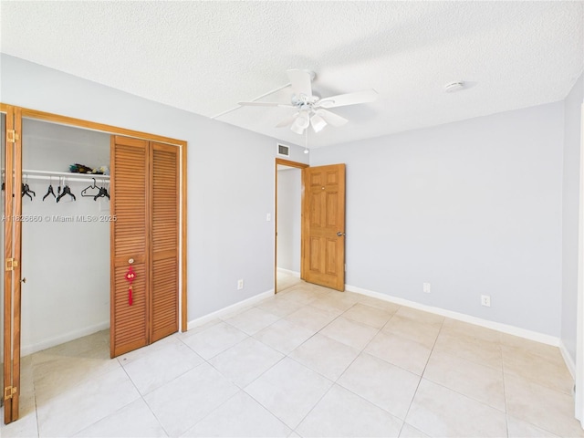 4113 NW 88th Ave Unit 105, Coral Springs, FL 33065 - unfurnished bedroom with a closet, a textured ceiling, ceiling fan, and light tile patterned flooring