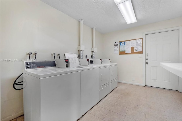 4113 NW 88th Ave Unit 105, Coral Springs, FL 33065 - shared laundry room with washing machine and clothes dryer and a textured ceiling