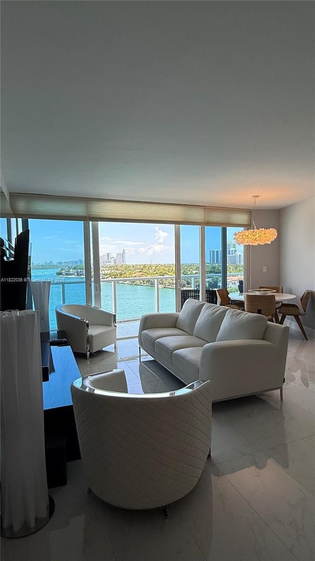 9821 E Bay Harbor Dr Unit 903, Bay Harbor Islands, FL 33154 - living area featuring healthy amount of natural light, a water view, and marble finish flooring