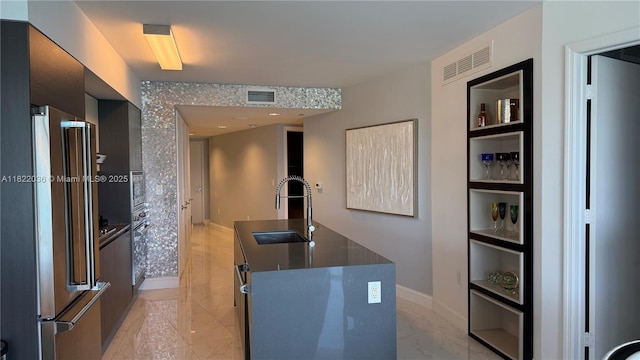 9821 E Bay Harbor Dr Unit 903, Bay Harbor Islands, FL 33154 - kitchen featuring high end refrigerator, built in features, modern cabinets, dark countertops, and an island with sink