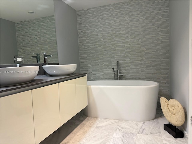 9821 E Bay Harbor Dr Unit 903, Bay Harbor Islands, FL 33154 - bathroom featuring double vanity, a freestanding bath, marble look tile flooring, and tile walls