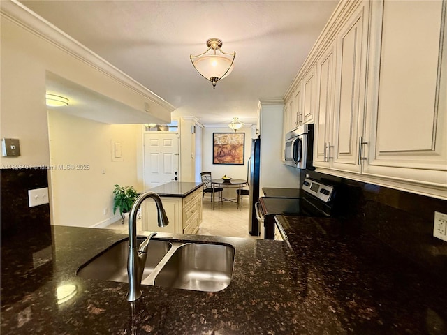 6404 Coral Lake Dr Unit 104, Margate, FL 33063 - kitchen featuring appliances with stainless steel finishes, dark stone countertops, and crown molding
