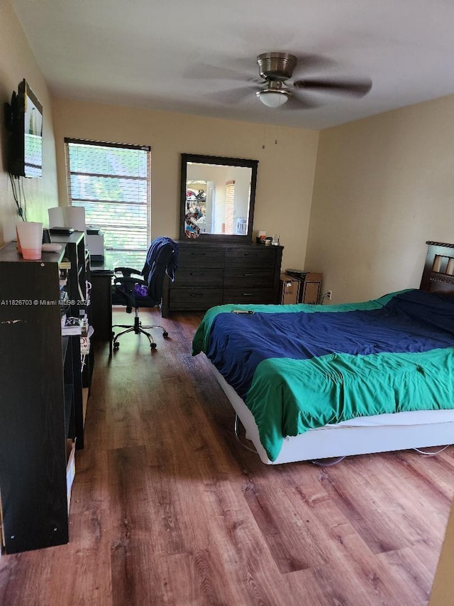 6311 NW 71st Ave, Tamarac, FL 33321 - bedroom with wood finished floors, an office area, and ceiling fan