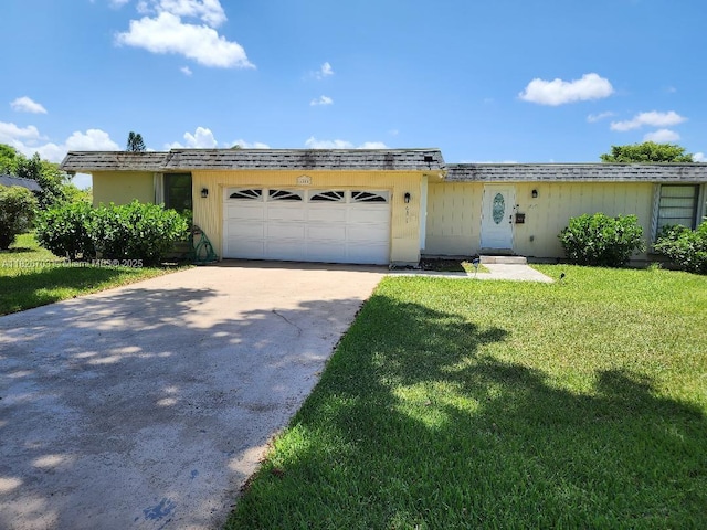 6311 NW 71st Ave, Tamarac, FL 33321 - view of front of house with concrete driveway, a front lawn, and an attached garage