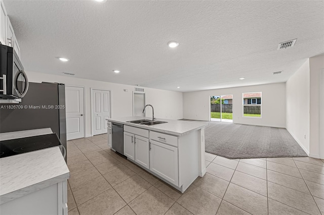 1230 Waterford, Palm Bay, FL 32909 - kitchen featuring appliances with stainless steel finishes, light carpet, light tile patterned floors, a textured ceiling, and light countertops