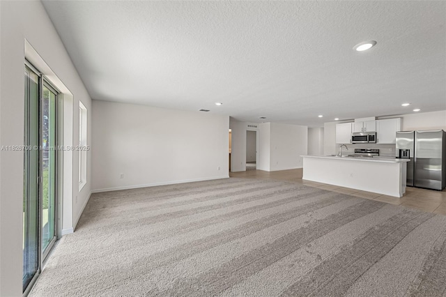 1230 Waterford, Palm Bay, FL 32909 - unfurnished living room featuring a textured ceiling, recessed lighting, and light carpet