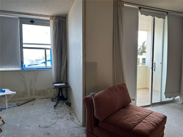3180 S Ocean Dr Unit 209, Hallandale Beach, FL 33009 - sitting room featuring healthy amount of natural light and a textured ceiling