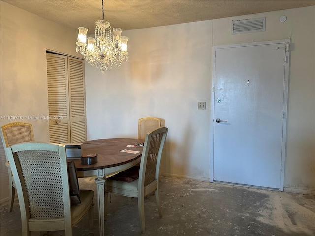3180 S Ocean Dr Unit 209, Hallandale Beach, FL 33009 - dining space featuring a chandelier, concrete flooring, and a textured ceiling