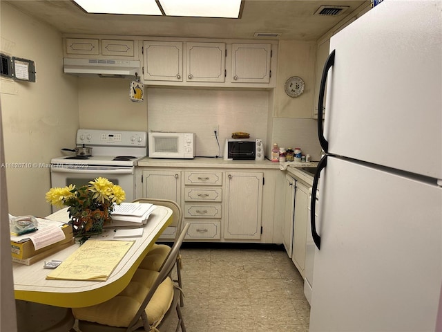 3180 S Ocean Dr Unit 209, Hallandale Beach, FL 33009 - kitchen with white appliances, under cabinet range hood, light countertops, and light flooring